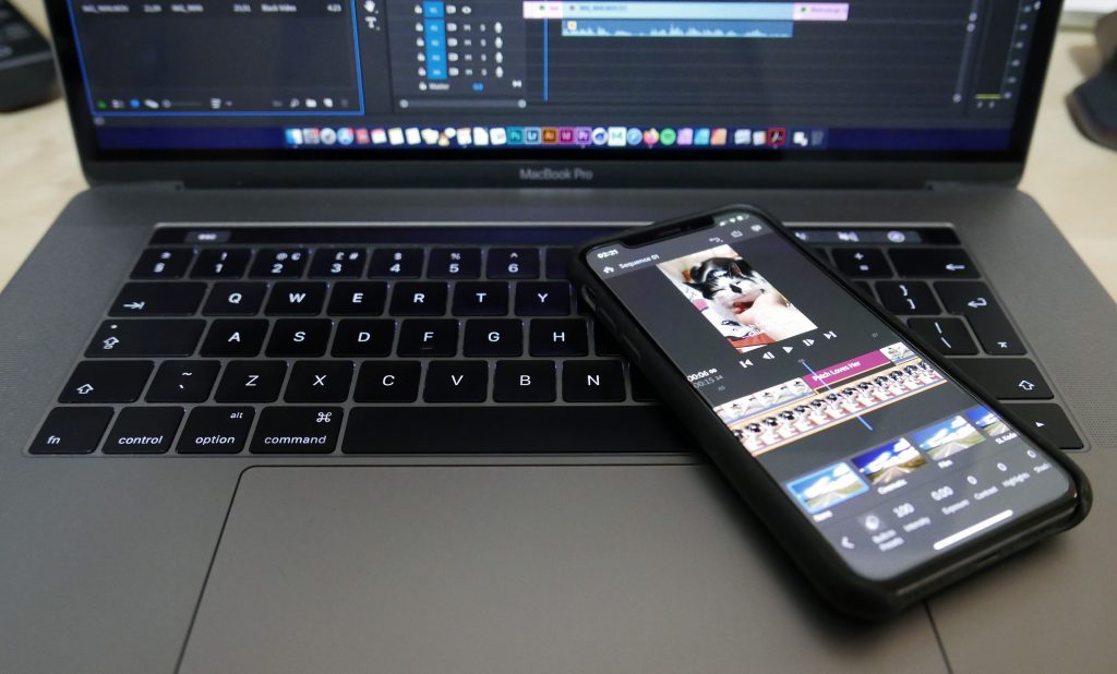 Video editing on both a mobile phone and a laptop computer.
