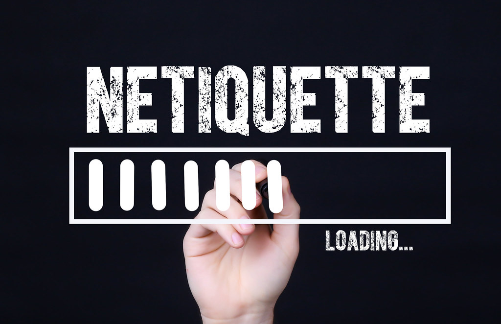 The word Netiquette being written on a board with the word loading underneath